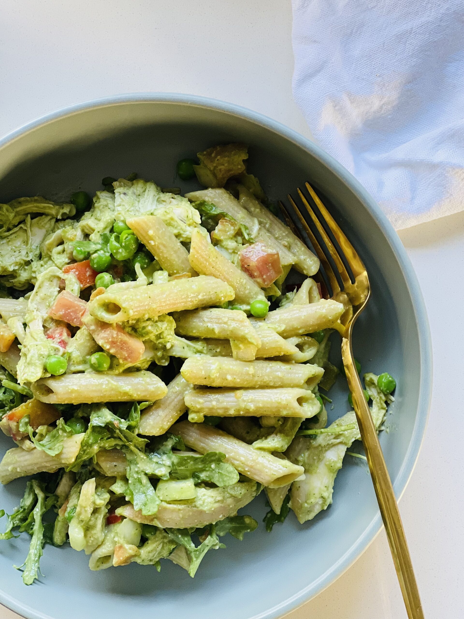 Coriander pesto recipe served over pasta with a sprinkle of parmesan cheese and fresh herbs.